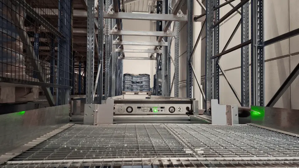 Automated shuttle system in a high-density warehouse storage rack.